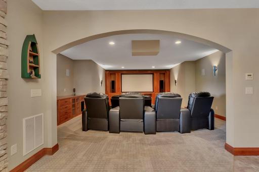 Step into this state-of-the-art home theater, where every movie night becomes an unforgettable experience! Featuring luxurious reclining leather chairs, surround sound, and a custom-built entertainment center with a massive screen.