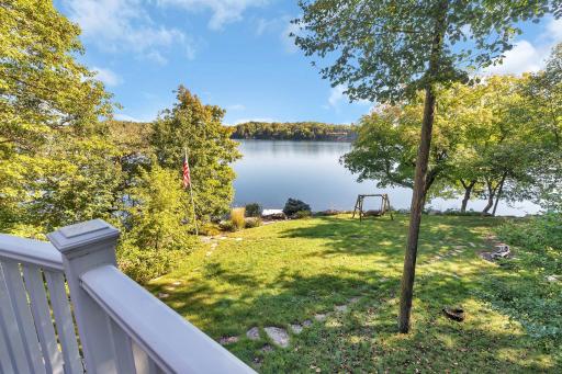 The view from the deck offers a stunning glimpse of the serene waters of West Lake Sylvia. The lake shimmers under the bright sky, inviting you to enjoy its peaceful beauty.