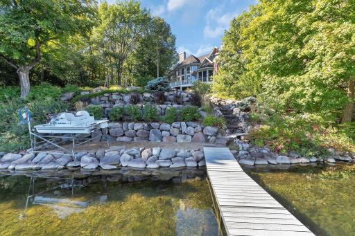 The outdoor oasis is equally impressive, with professionally landscaped grounds and a tranquil waterfall just steps from the shoreline.