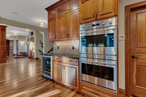 This amazing kitchen with custom cherry cabinetry, under cabinet lighting, stainless steel double ovens, and a large walk-in pantry is ideal for both cooking and entertaining.