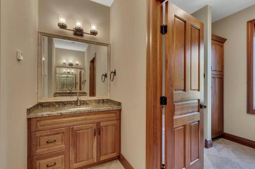 This upper-level full bathroom is thoughtfully designed with a dual sink area separate from the shower/ bath area for convenience and privacy. Located between the 2nd and 3rd bedrooms, it serves as a shared space, ideal for family or guests.
