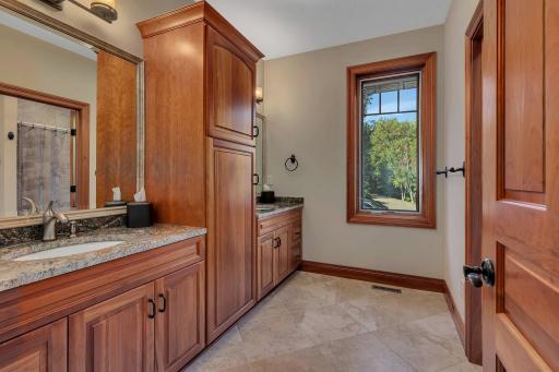 This upper-level full bathroom is beautifully designed with dual sinks and separate shower and tub area, providing convenience and privacy. Situated between the fifth and sixth bedrooms, it is perfect for accommodating family or guests.