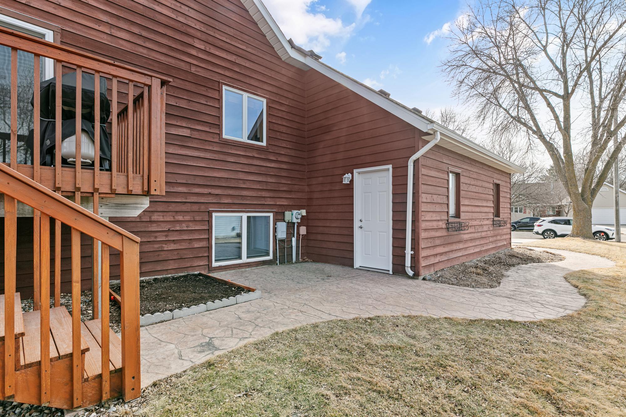 Patio, garage entrance and walkway to the driveway