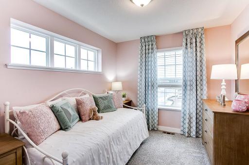 Another of the three upstairs bedrooms. Photo of end unit model, colors are similar.