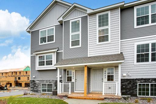 Gorgeous exterior and landscaping, nice front porch. This is the model, located at 6665 Hinterland Trail S.
