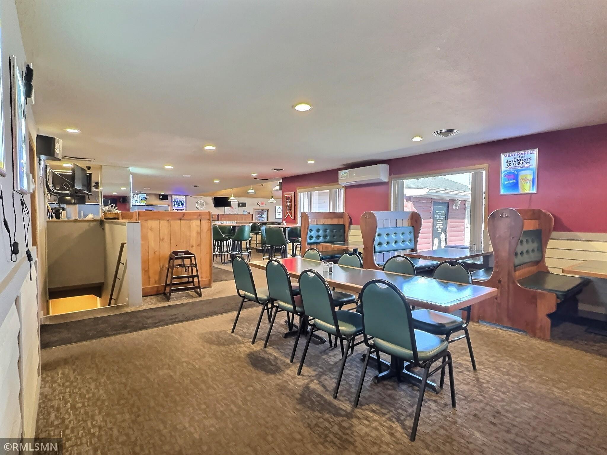 Another dining area with tables and booths. Restrooms are located in this part of the restaurant.