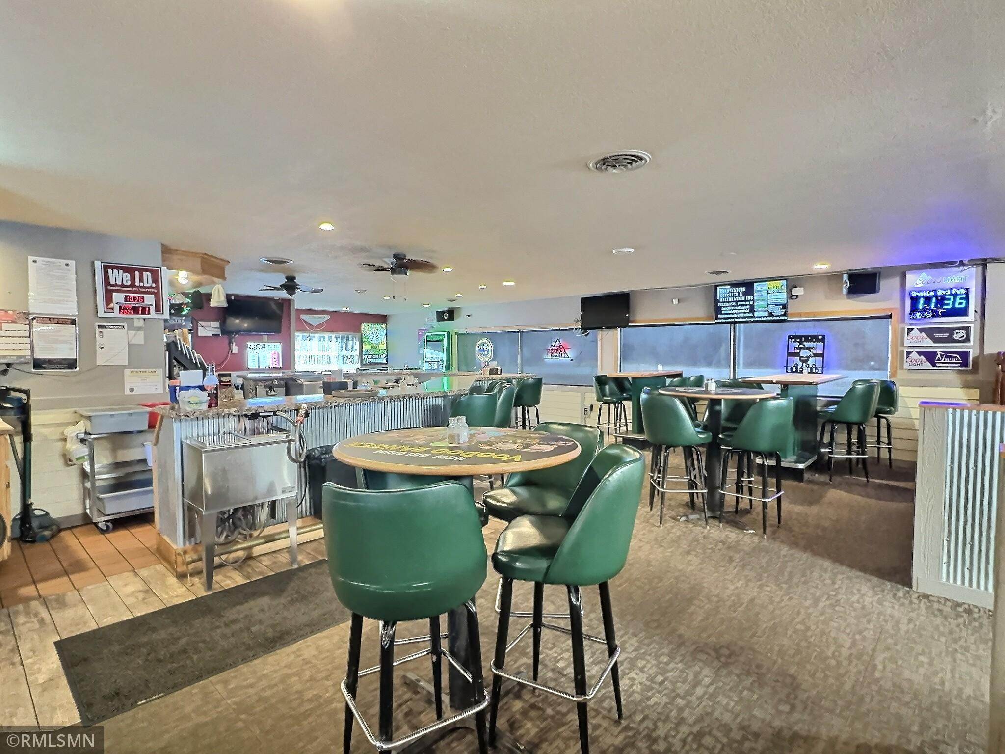 Inside, the bar seamlessly connects to multiple dining areas, creating a welcoming and versatile space.