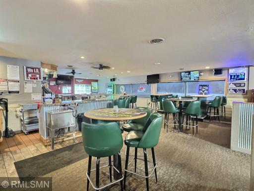 Inside, the bar seamlessly connects to multiple dining areas, creating a welcoming and versatile space.
