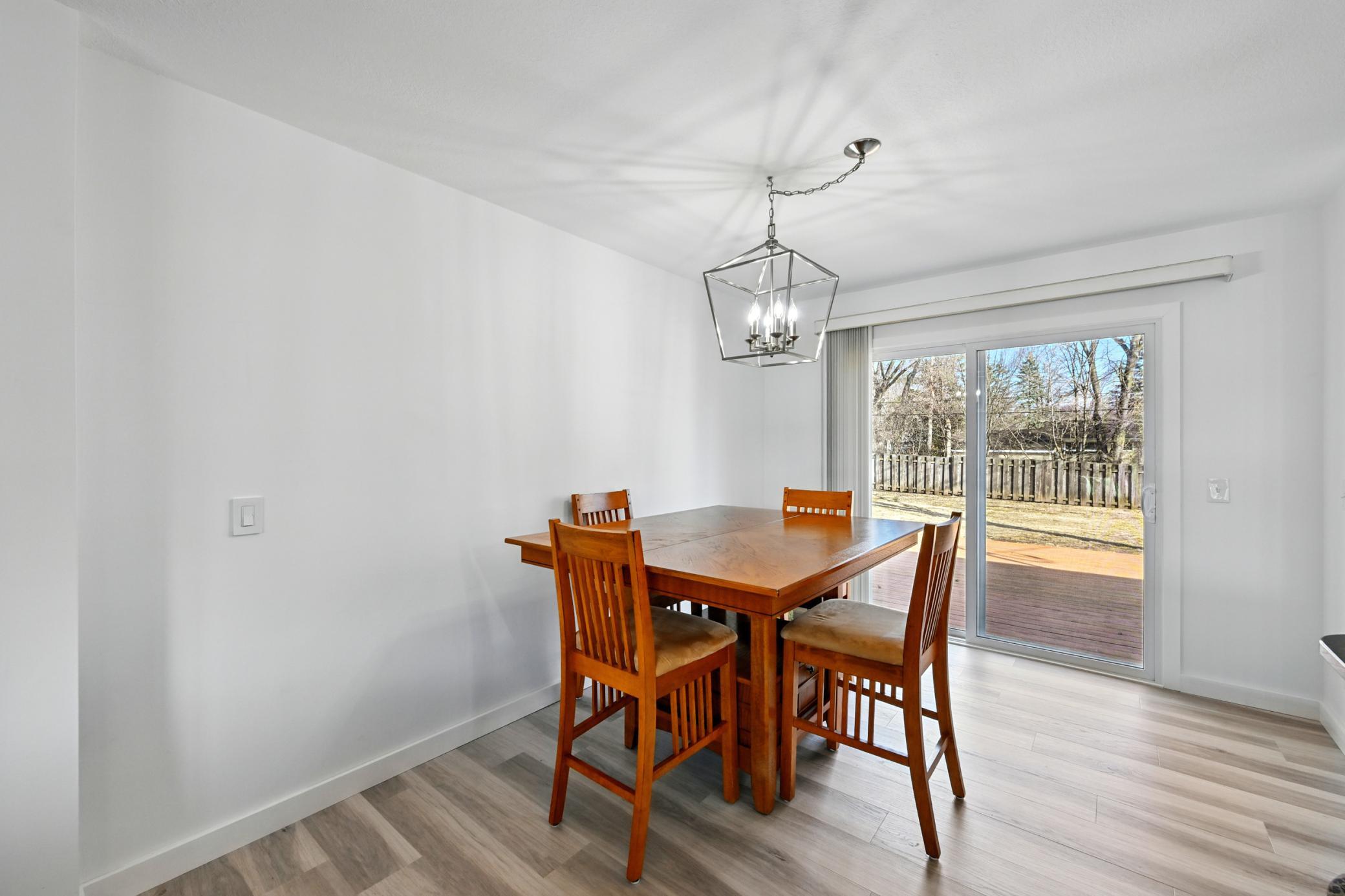 Main level informal dining room with new flooring and ample natural light