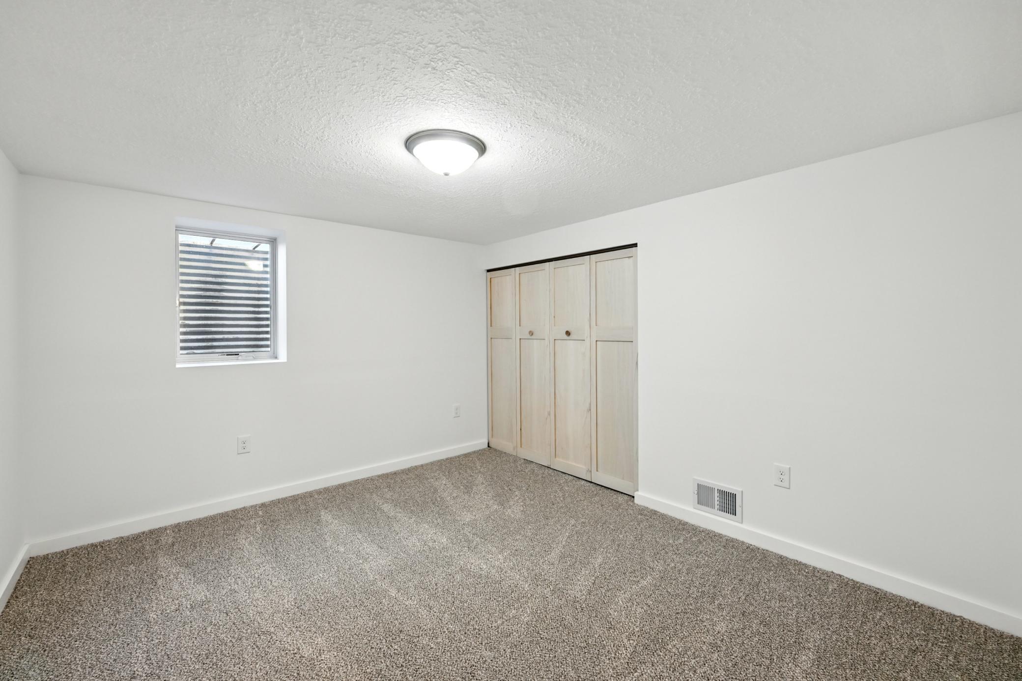 4th bedroom located on the lower level with a large closet and new plush carpet