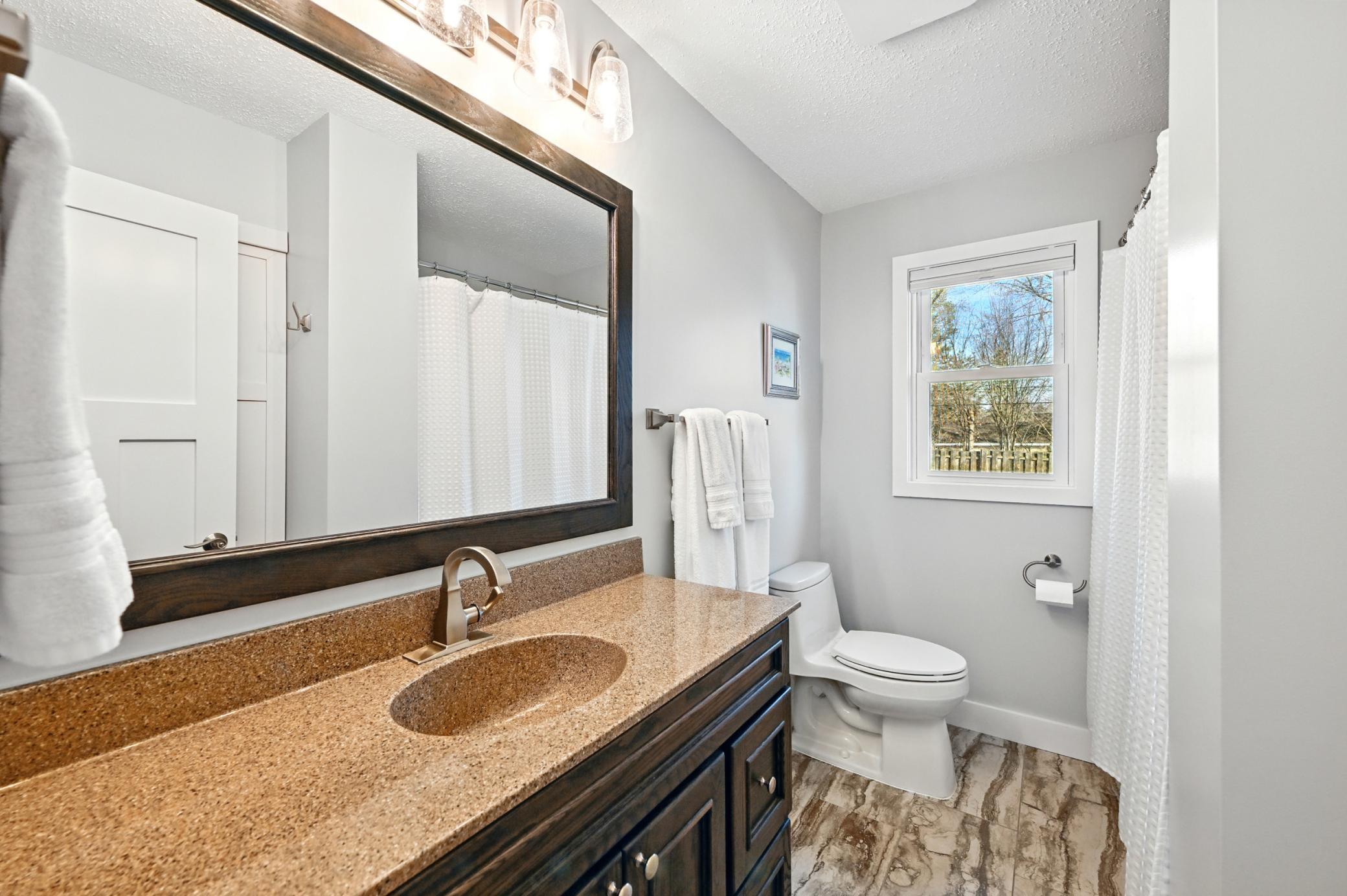 Recently renovated main level full bathroom with a large vanity