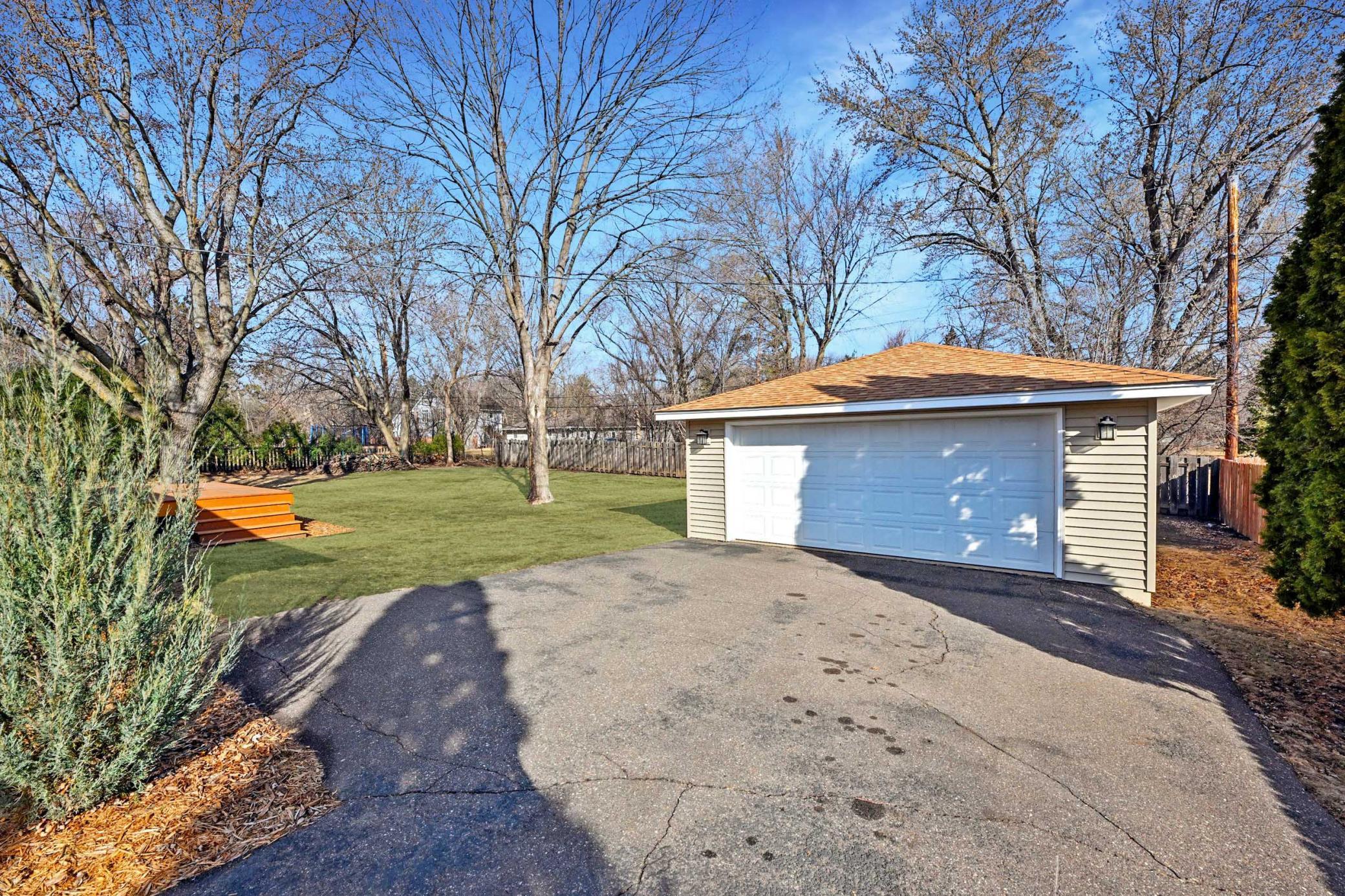 Spacious detached garage and backyard with well maintained landscaping- grass has been touched up