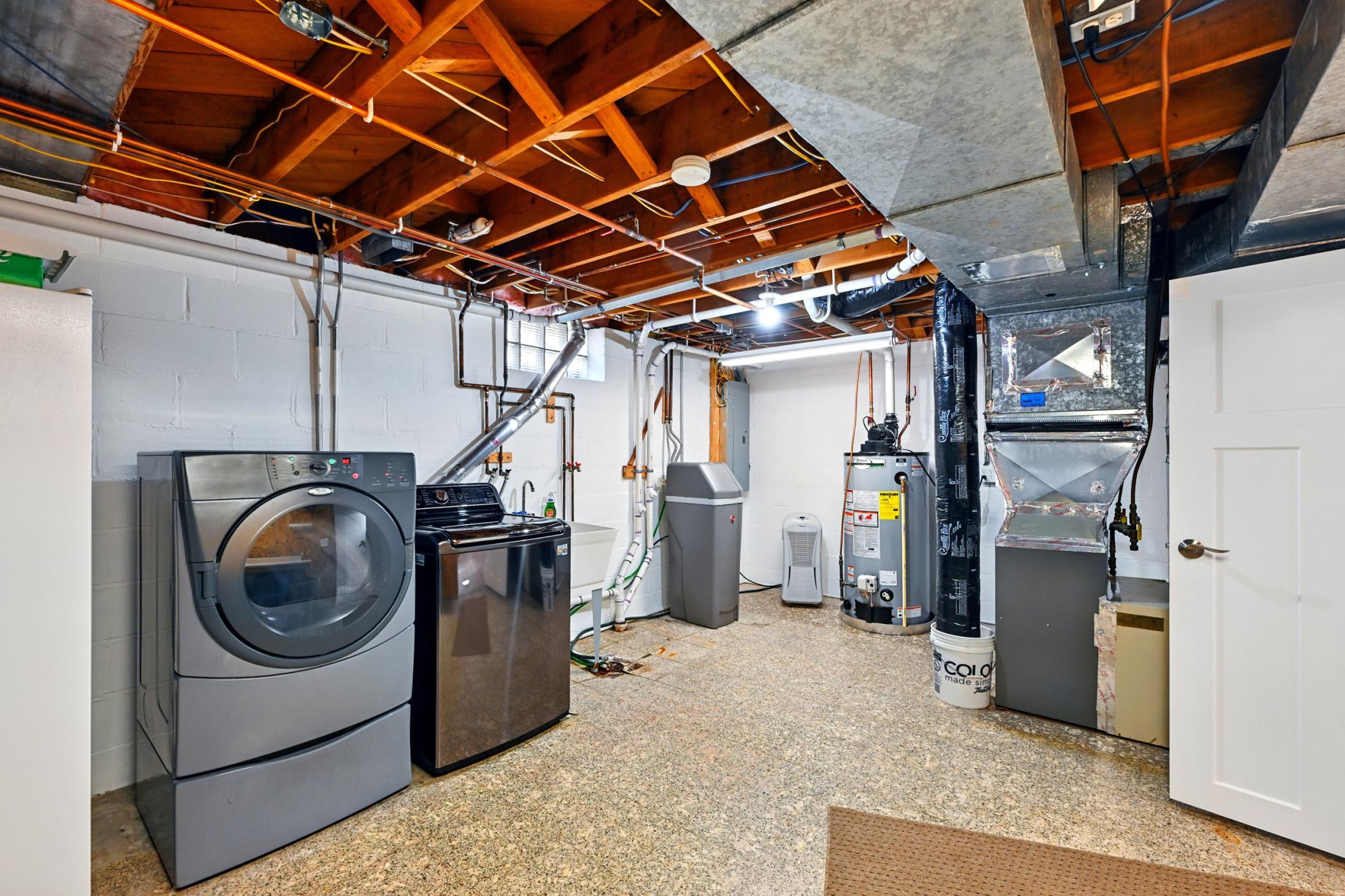 Large lower level laundry and storage room with ample room for holiday decor