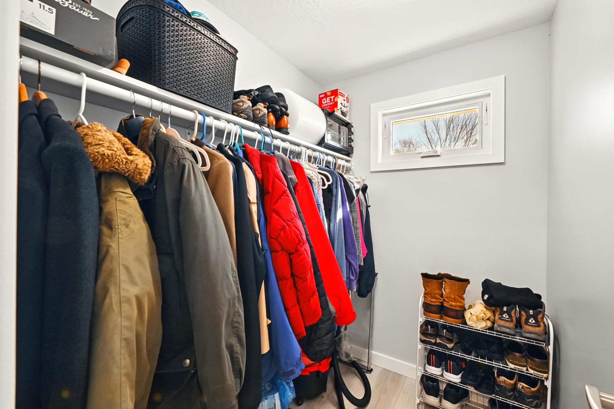 Large walk in closet with ample storage room and new flooring