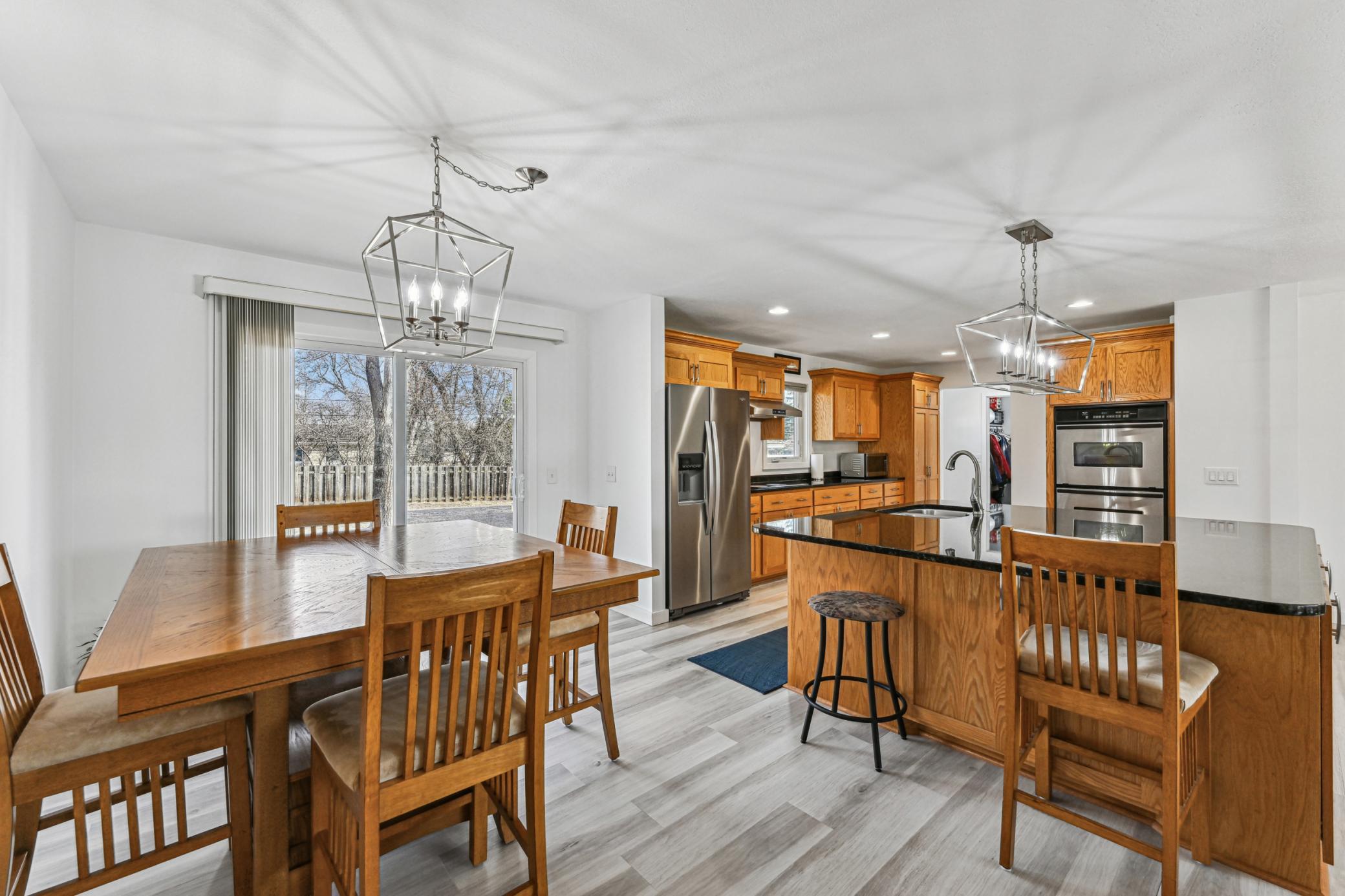 Main level kitchen and dining room with matching pendant lighting