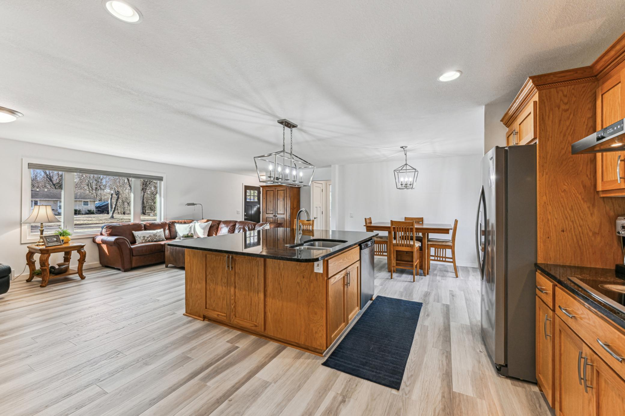 Spacious main level kitchen with a large center island and elegant lighting throughout