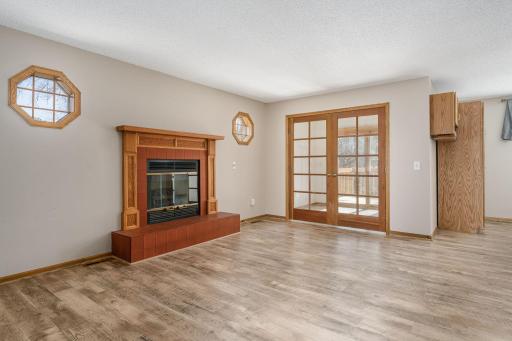 French doors lead to the sunroom, expanding your living space and bringing the outdoors in.