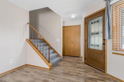 Step into a welcoming entryway with LVP flooring, neutral tones, and convenient closet storage.