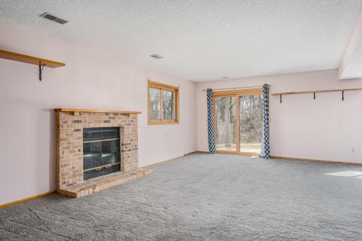 Large windows and sliding glass doors flood the space with natural light and walks out to a private patio.