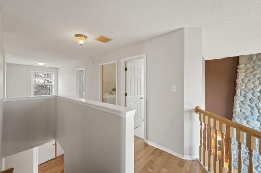 Hallway loft view of the Stone fireplace and the 2 story picture window