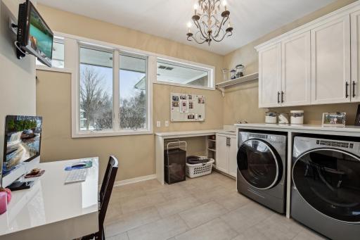 Main level laundry room with planning desk area, and pantry space.