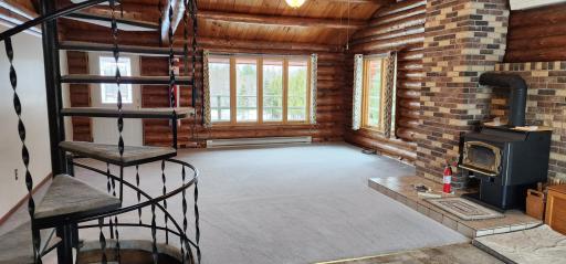 Photo for 2260 County Road 98, International Falls, MN 56649 - Listing #6686198 Large windows in living room provide so much natural light and the fireplace help provide for cozy nights.