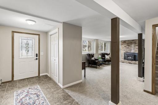 Lower level family room with wood burning fireplace