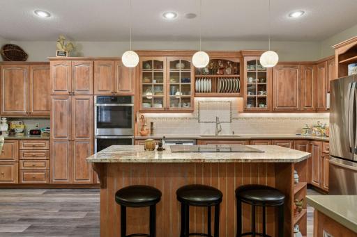 Tons of storage with pullouts, planning desk, stainless steel appliances and granite center island.
