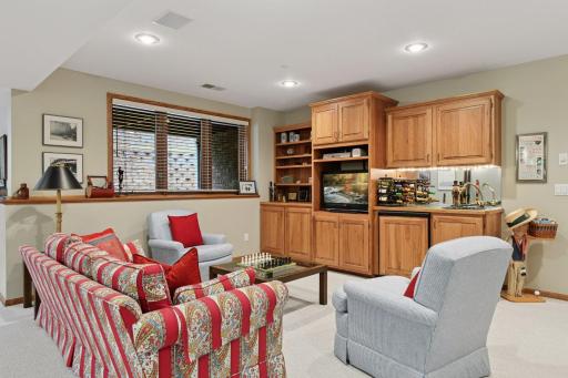 Lower level seating room with built-ins and a wet bar, great for movie nights and big games!