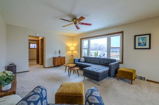 Living Room (Alternate View) â Alternate angle highlighting natural light and open sightlines to dining area. Comfortable layout supports everyday living and entertaining.