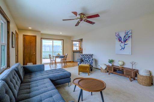 Living Room (Alternate View) â Alternate angle highlighting natural light and open sightlines to dining, doorway to deck and kitchen.