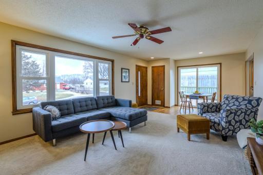 Living Room (Alternate View) â Alternate angle highlighting natural light and access to the deck and front door.