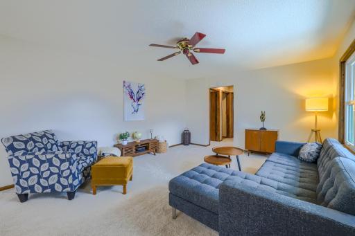 Living Room â Spacious main-level living room with large front-facing windows that provide abundant natural light. Neutral finishes and an open layout offer flexibility for furniture placement and easy flow to the dining area and kitchen.