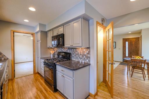 Kitchen with Gas Range & Dining Access - Includes a gas range, built-in microwave, and ample upper and lower cabinetry for storage. The open doorway connects directly to the dining area, enhancing flow for daily living and entertaining.