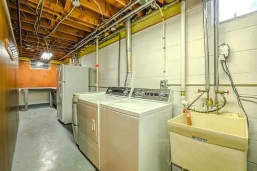 Utility/Laundry Room â Unfinished Lower Level - Unfinished lower-level utility and laundry area includes washer, dryer, extra refrigerator/freezer, utility sink, and mechanical systems. Offers 336 sq ft of flexible space for storage or hobbies.