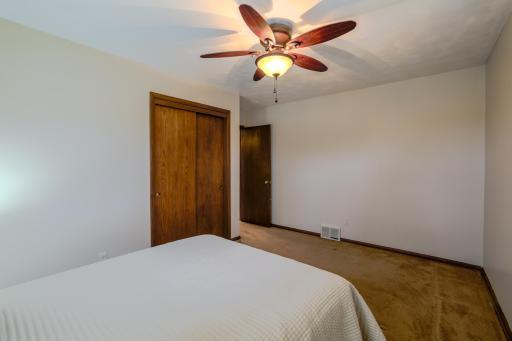 Primary Bedroom â Alternate Angle â Additional view highlights room dimensions, neutral finishes, and functional layout. Dual windows and overhead lighting enhance everyday comfort within this main-level primary bedroom.