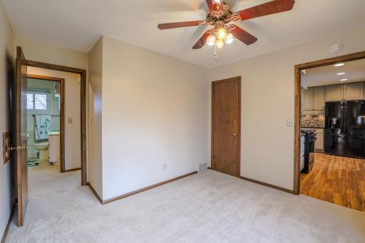 Flexible Bed/Dining room (alternate angle) without staging. View of kitchen doorway at right and access to hallway and bathroom at left.