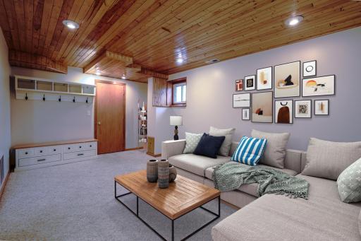 Lower-Level Family Room with Wood Ceiling - Finished basement living space with tongue-and-groove wood ceiling, recessed lighting, and neutral carpet. Ideal for media room, home office, or flex space. (Virtually Staged)