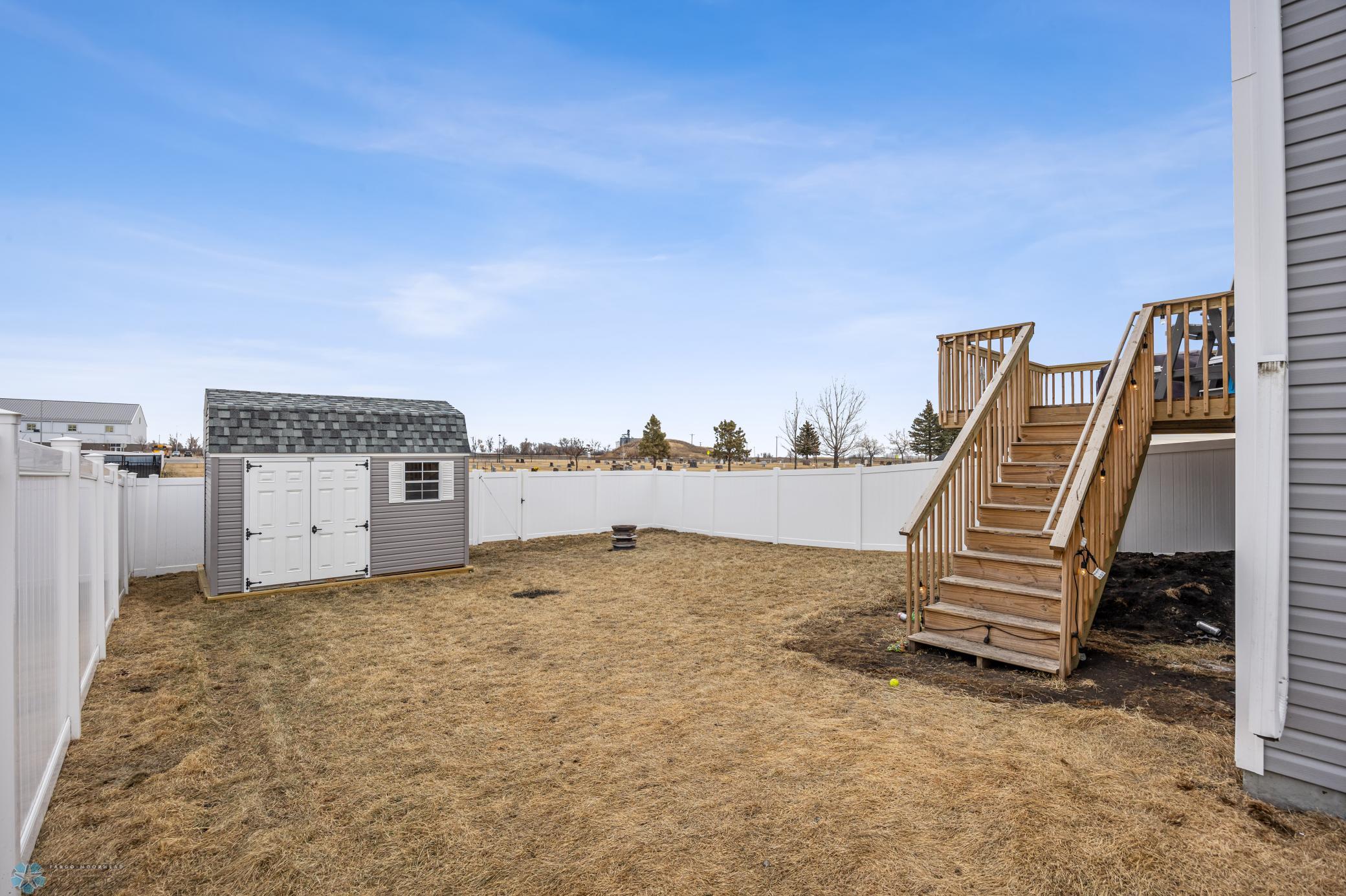 Fully fenced yard with shed