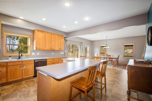 The large center island is perfect with bar stools for everyone to gather around the heart of them home!