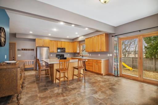 The kitchen is spacious with ample cabinet and counter space.