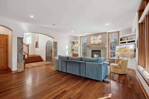 Spacious living room with hardwood floors, built in entertainment, cozy gas fireplace and natural light.