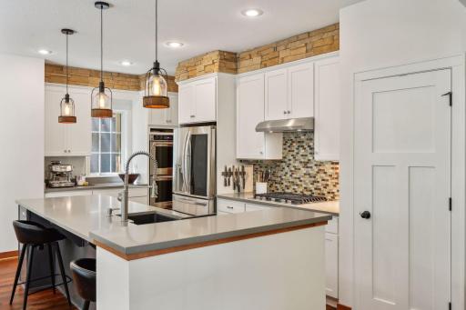 The kitchen is a chefâs dream, boasting a large center island and a walk-in pantry.