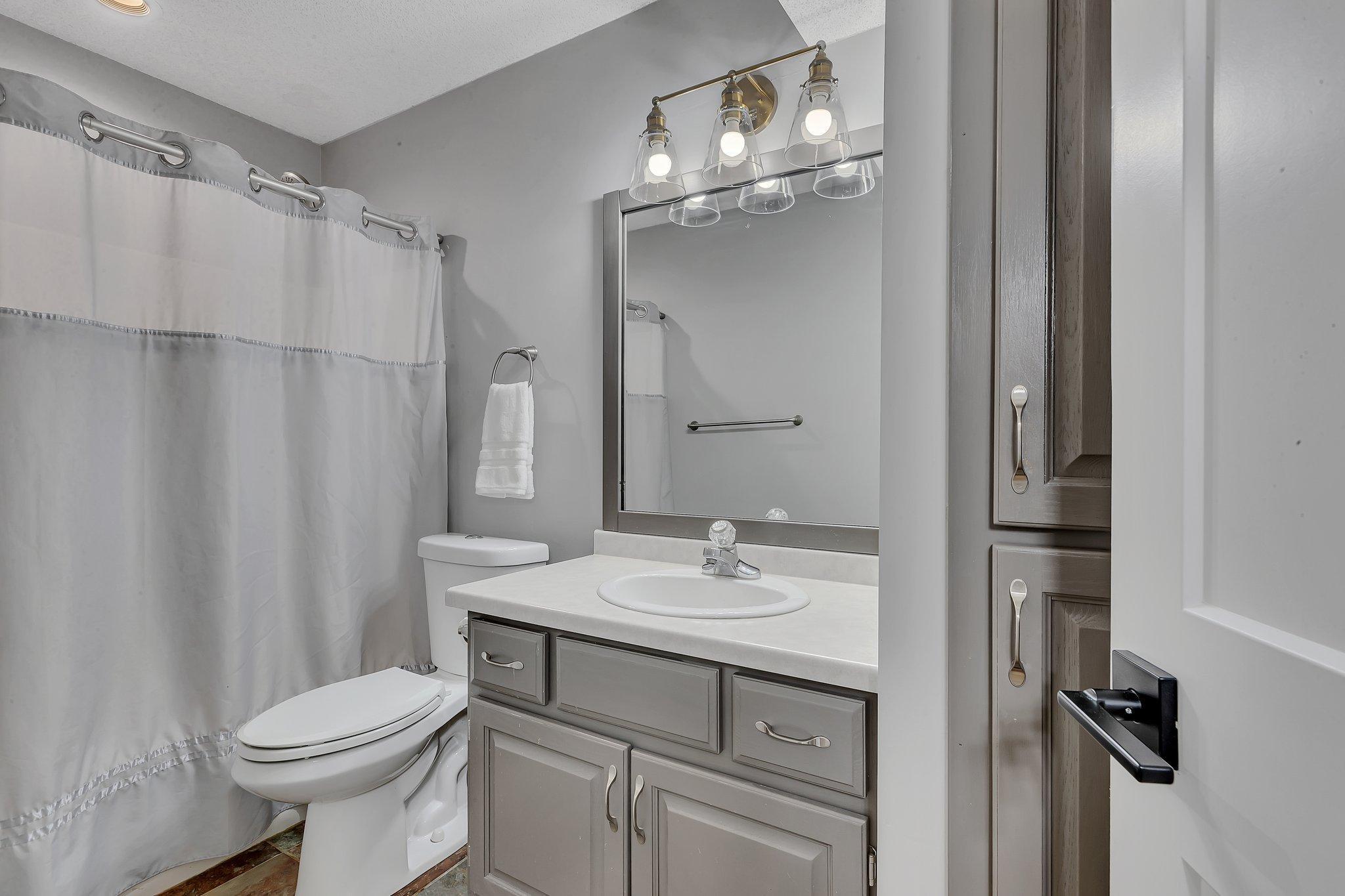 3rd Level Full Bathroom with Fresh Paint and New Lighting