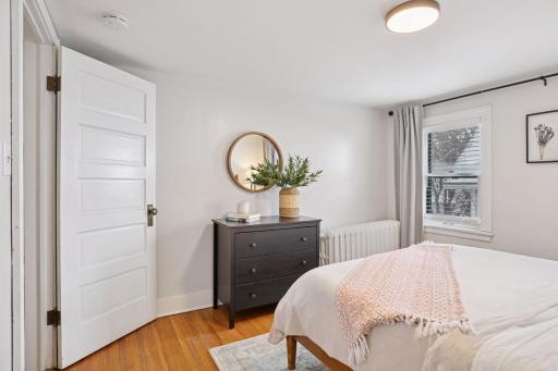 Upper level bedroom filled with natural light from the multiple large windows