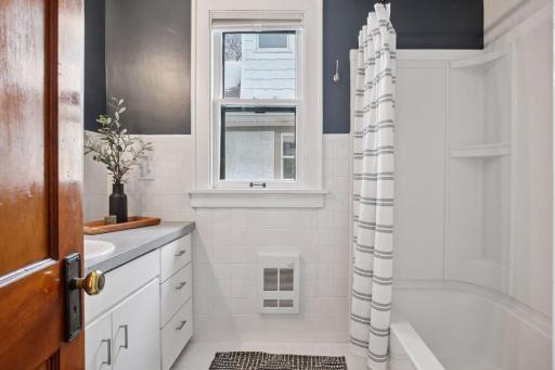 Main level bedroom with crisp white tiles