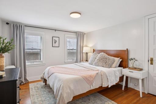 Upper level bedroom with gleaming hardwood floors and a large closet