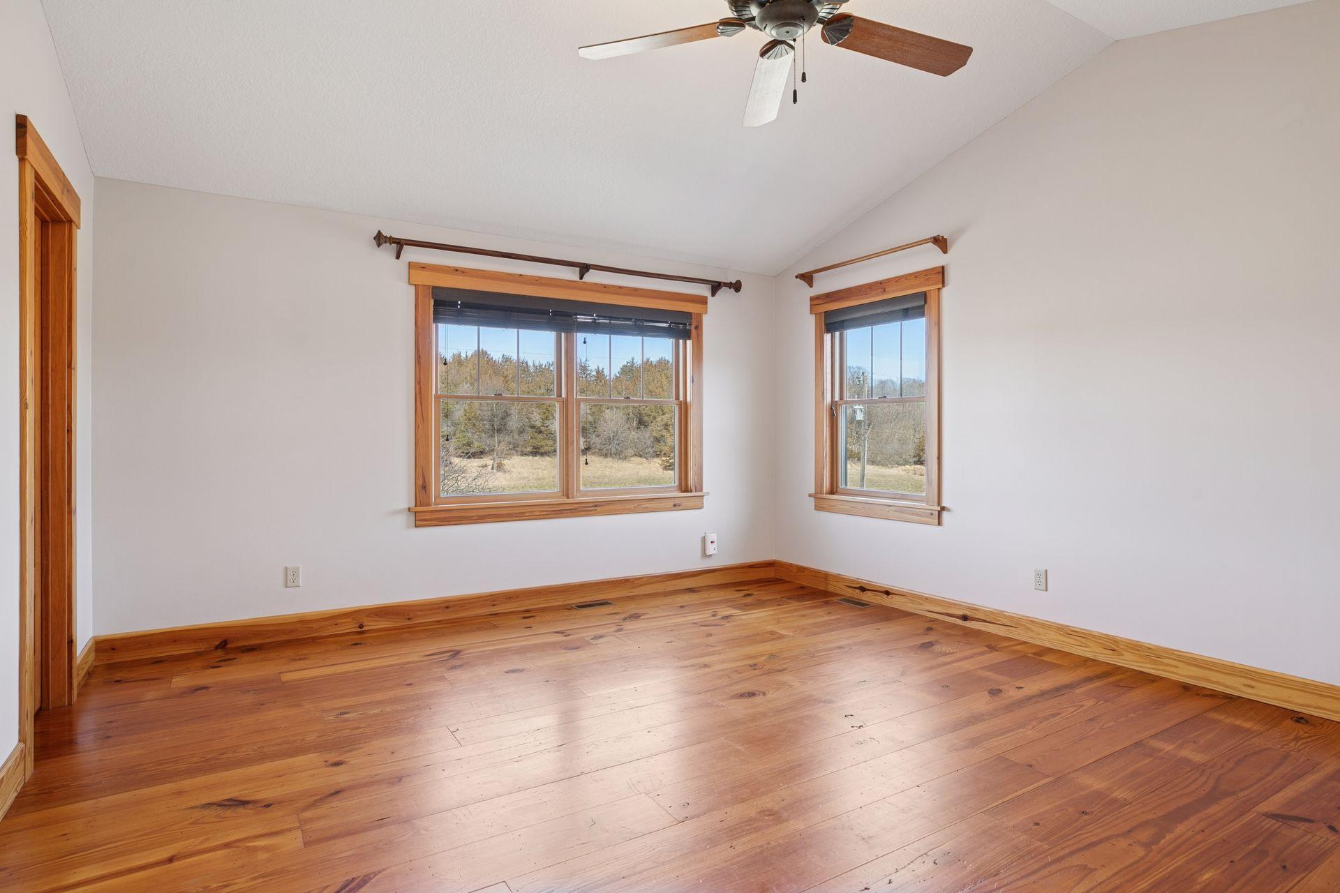 Spacious primary bedroom with vaulted ceiling