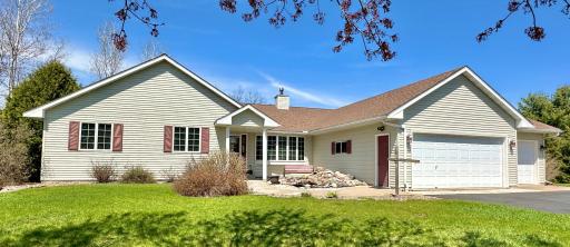 Great curb appeal and nicely landscaped home sitting on 2+ acres a stones throw away from the Apple River.