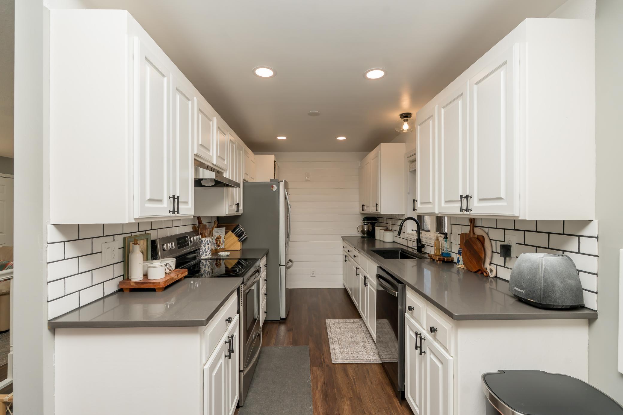 Updated kitchen with new cabinets, countertops, lighting, flooring, appliances and backsplash. *Not pictured on the other side of the refrigerator is a pantry!